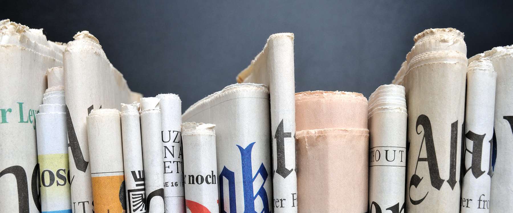close up of news papers on book shelf