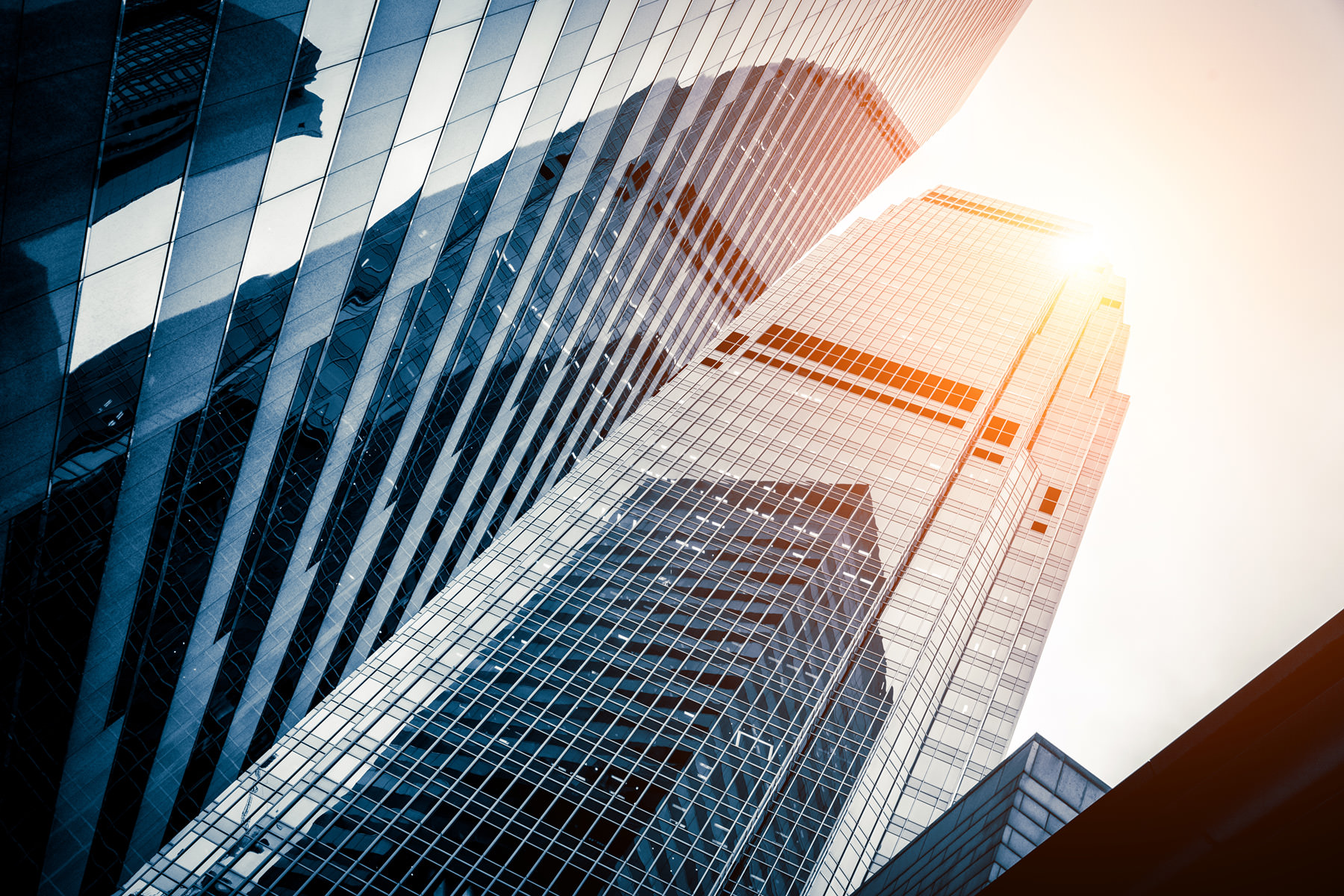 looking up at skyscrapers and into the sun